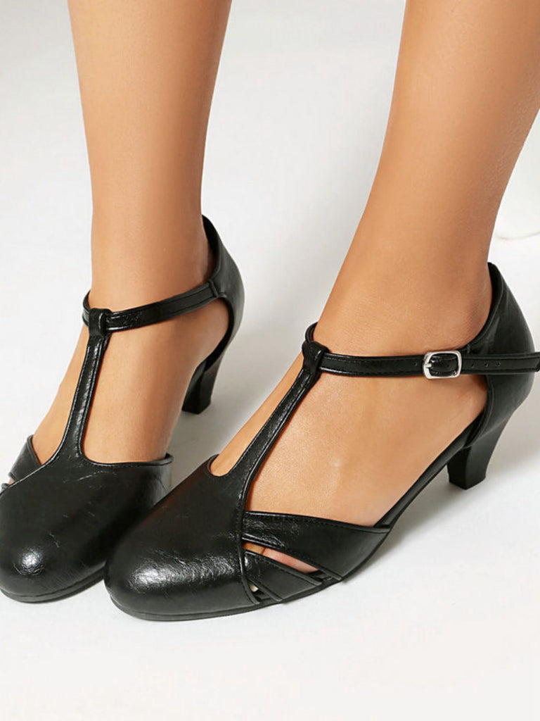 Black leather shoes with closed-toe design on a white background