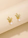 Gold starfish earrings with pearl drops on a beige background
