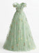 Green floral embroidered dress on a white background