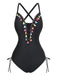 Un maillot de bain une pièce noir doté d'un décolleté en V profond orné de pompons colorés et de détails à nouer sur les côtés.