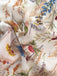 Close-up of floral fabric with colorful flowers and leaves on a beige background