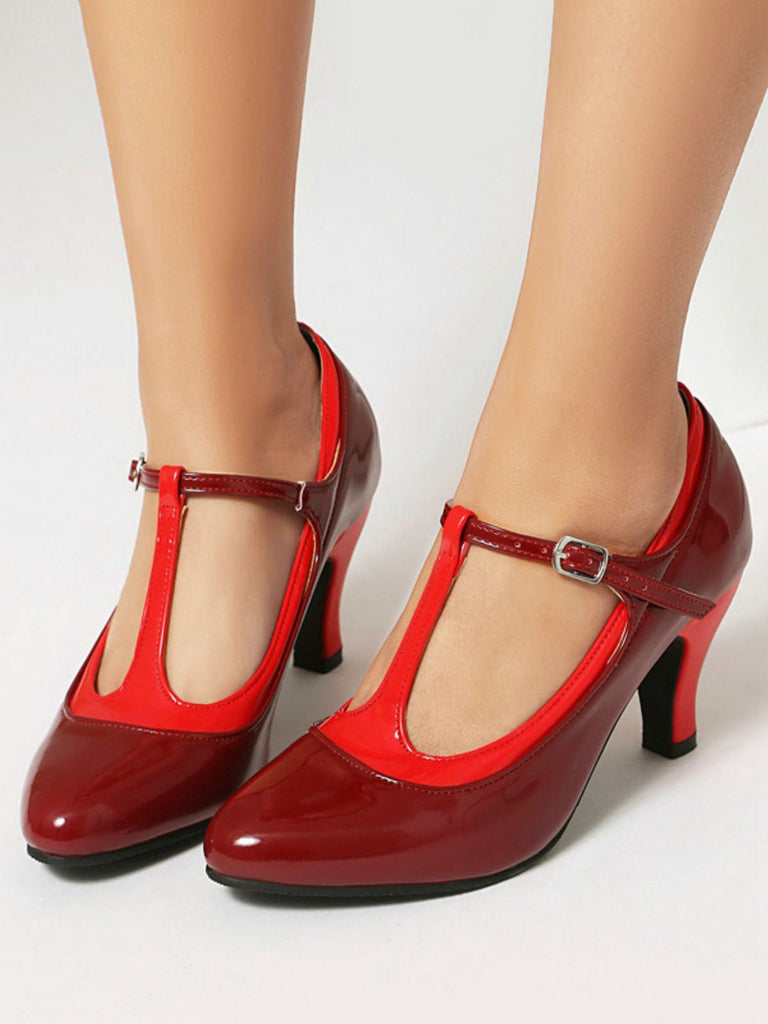 Red high-heeled shoes with a T-strap on a white background