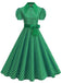 Robe trapèze vintage à pois, ceinturée et à col chemise, dans un style rétro classique des années 1950.