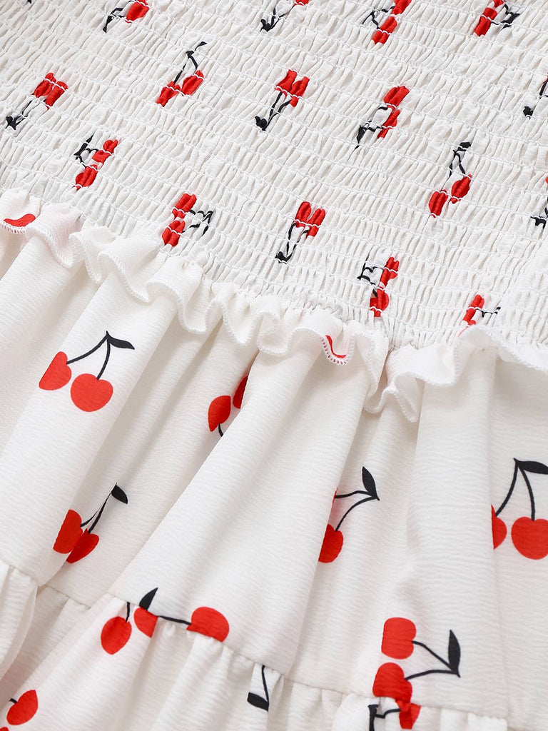 Robe blanche manches bouffantes et épaules dénudées motif cerise des années 1950