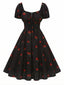 Robe noire imprimé cerises manches bouffantes années 1950