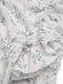 Robe bleue à volants et épaules dénudées motif floral des années 1930