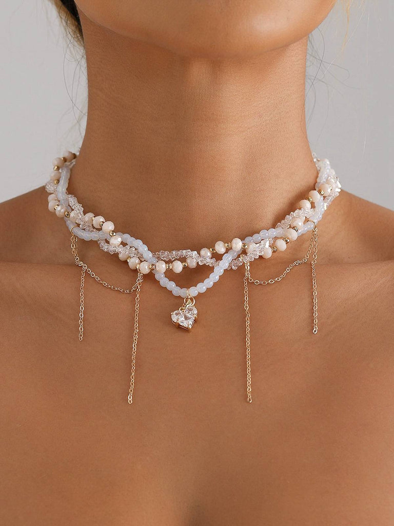 Collier de perles avec pendentif en forme de cœur blanc et strass