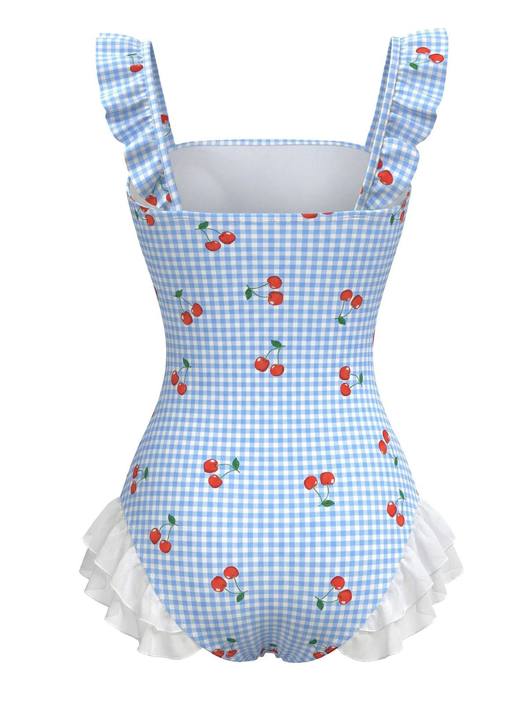 Blue gingham swimsuit with red cherries and white ruffles on a white background