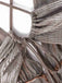 Close-up of a metallic fabric with intricate patterns and textures.