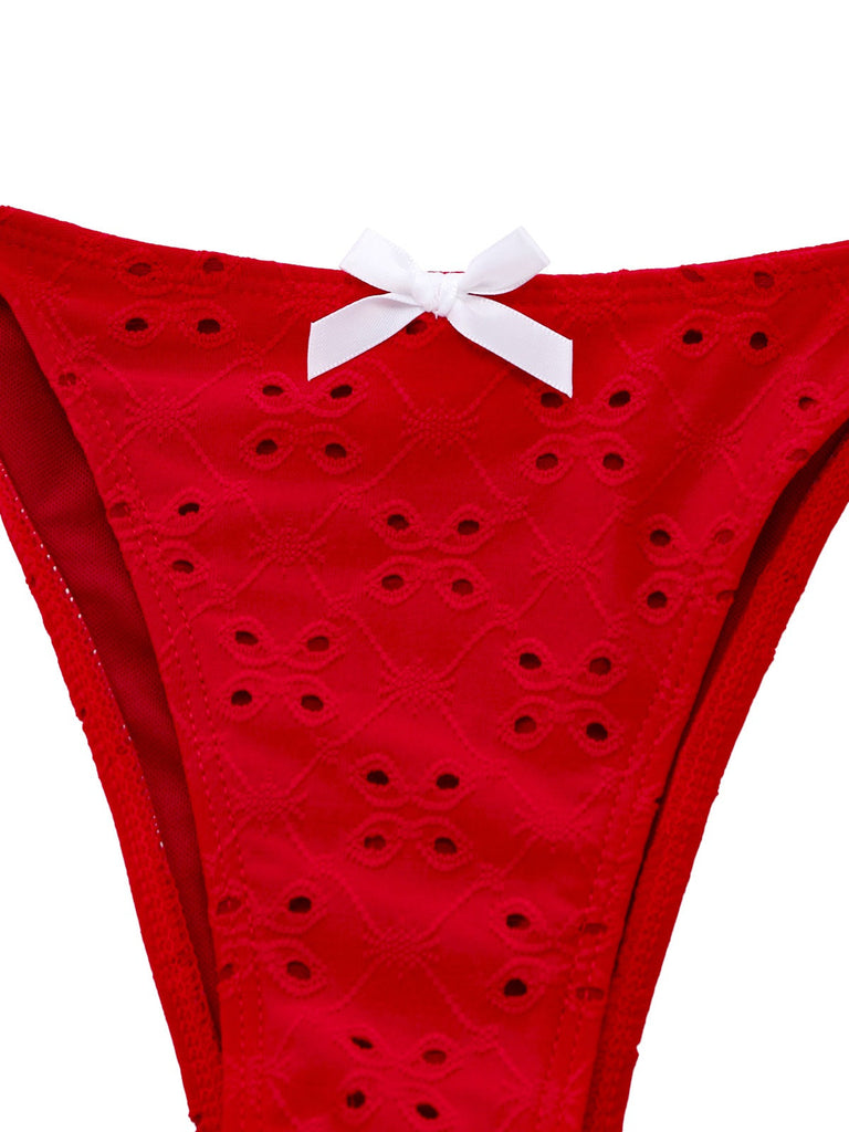 Red polka dot bikini bottom with a white bow on a white background