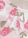 Macro view of the fabric edge and stitching on the white and pink rose print material.